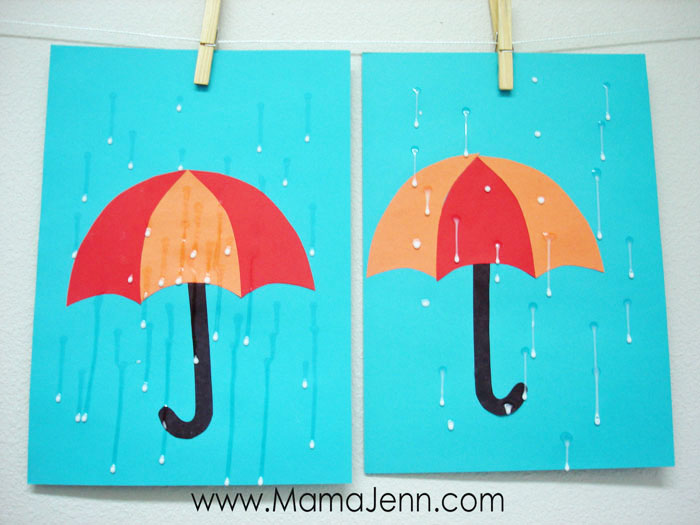 blue construction paper with red and orange umbrella craft with wet glue as raindrops