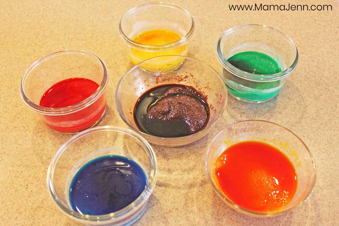 six bowls with colored sand being made in them