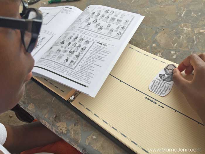 boy adding timeline figure to Home School in the Woods Record of History timeline notebook