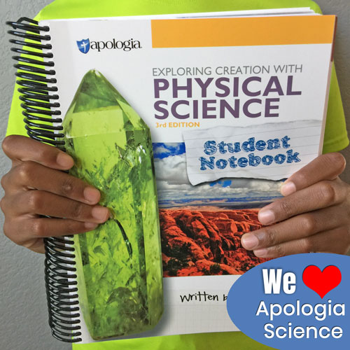 hands holding an Apologia Physical Science Student Notebook